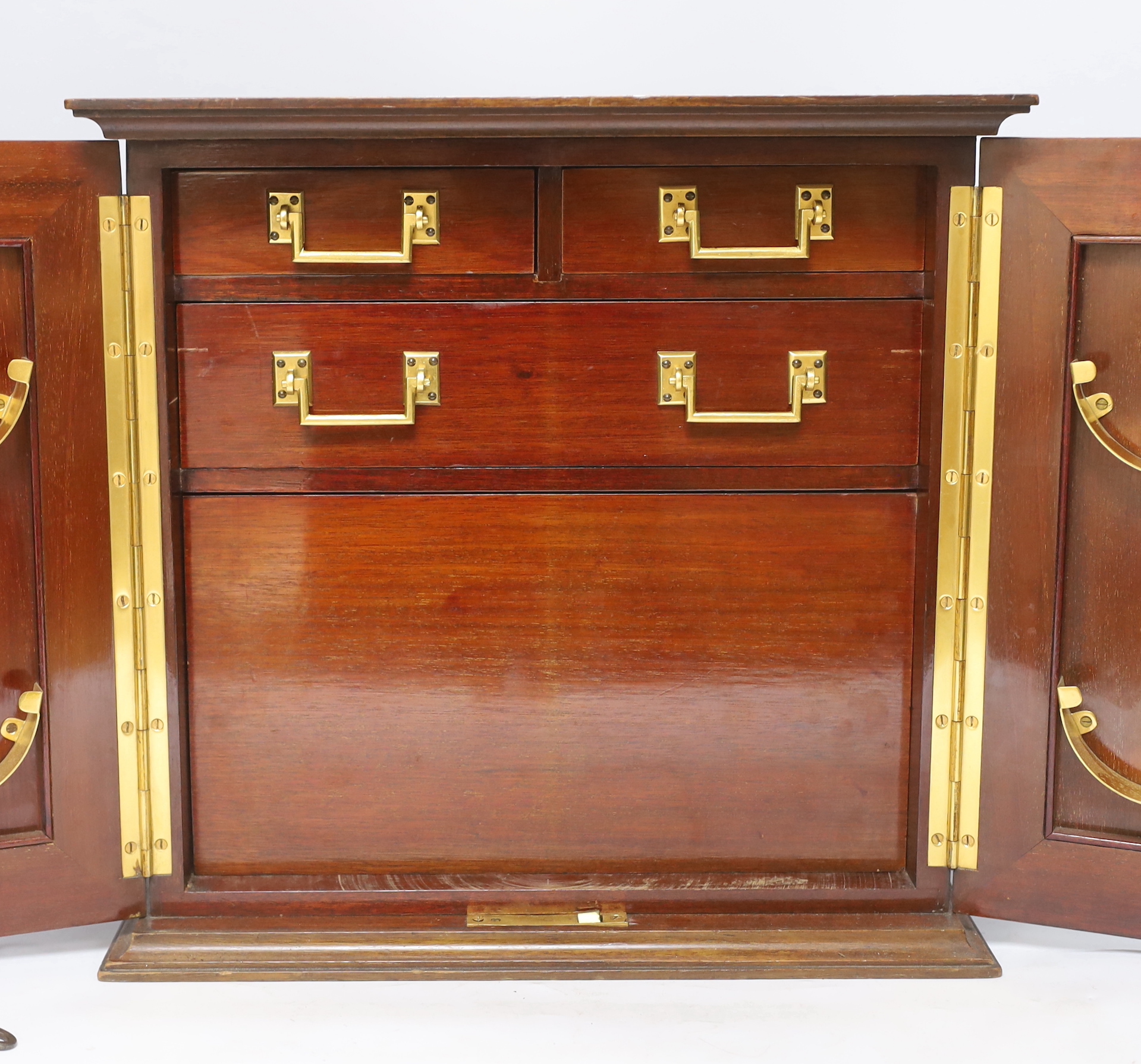 A mahogany smoker's cabinet with tobacco jar and three Jose L Piedra Cuba cigars, 35cm high